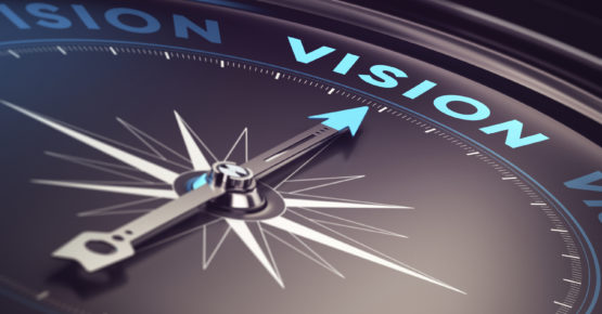 Compass with needle pointing the word vision with blur effect plus blue and black tones. Conceptual image for immustration of company or business anticipation or strategy